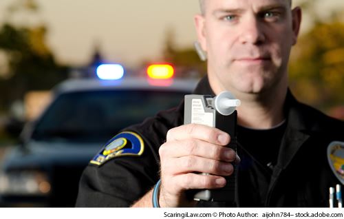 officer with a breathalizer