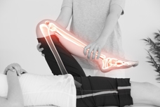 An injured person receiving physical therapy help on their left leg