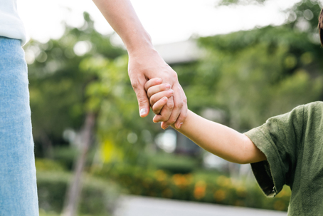 Parent holding child's hand