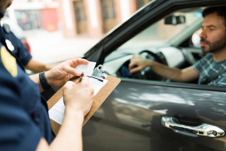 Police writing a ticket to man who was pulled over