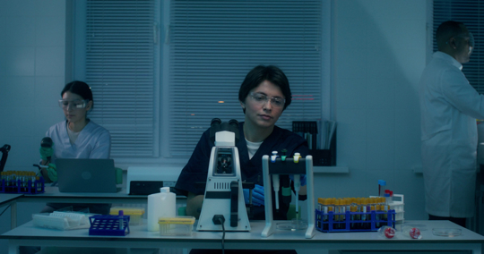 A group of laboratory assistants in medical clothes work in a medical laboratory