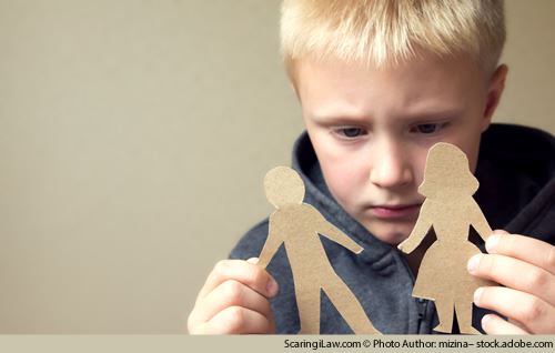 child playing with paper cutout parents